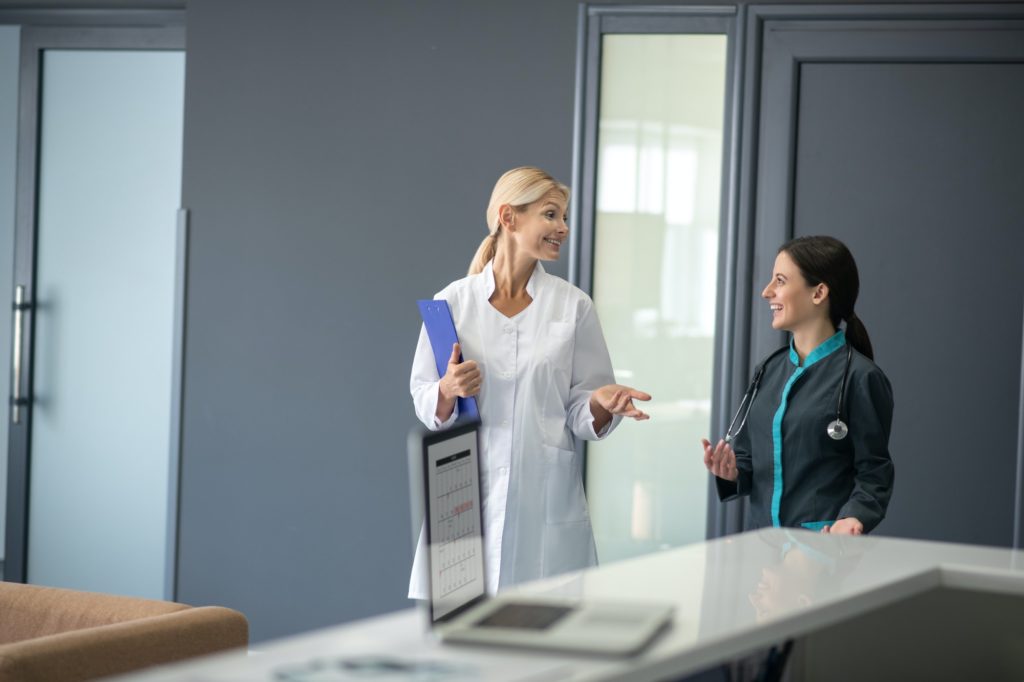 Intern and senior doctor talking in the doctors office